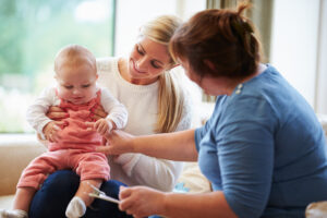 Health Visitor Talking to Mother and Young Baby